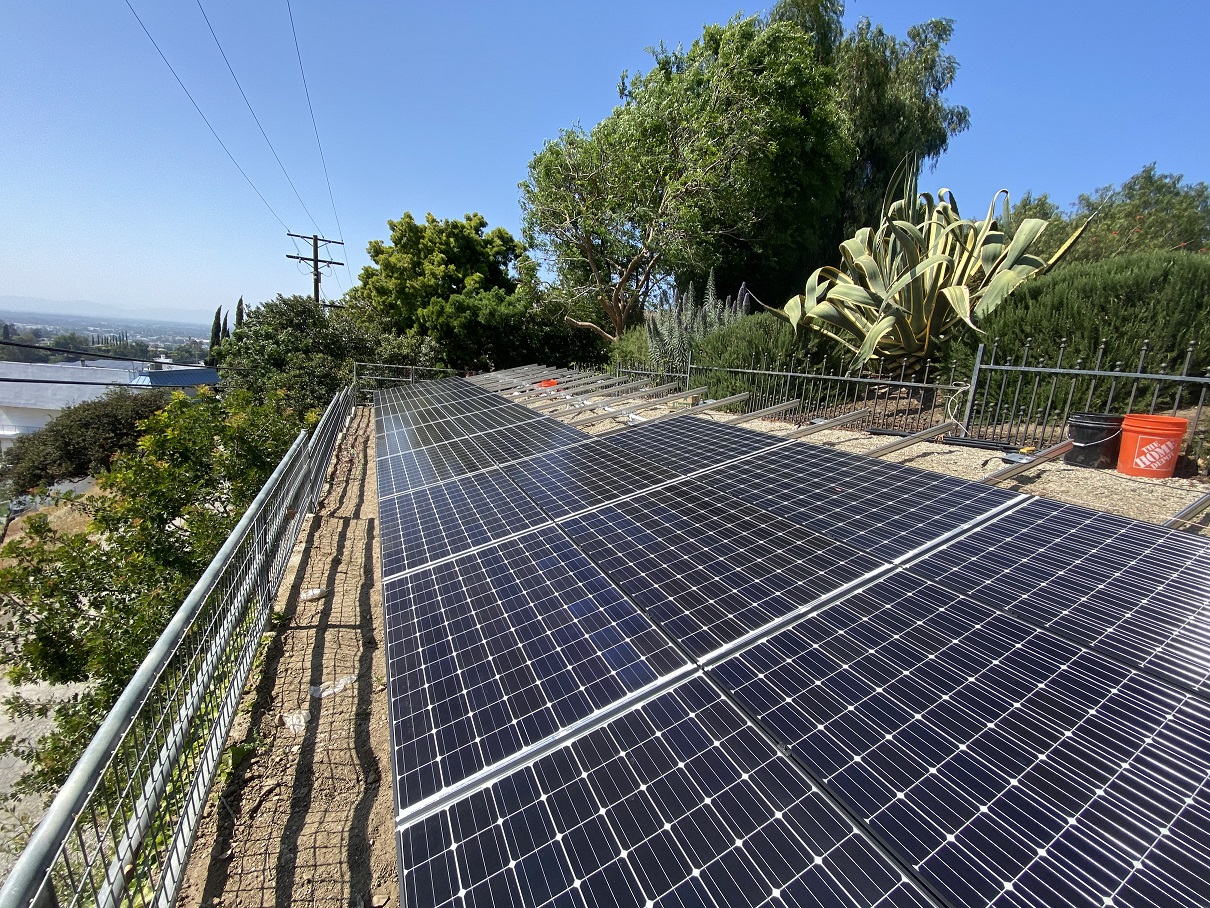 A solar panel is mounted discount on the roof of a house