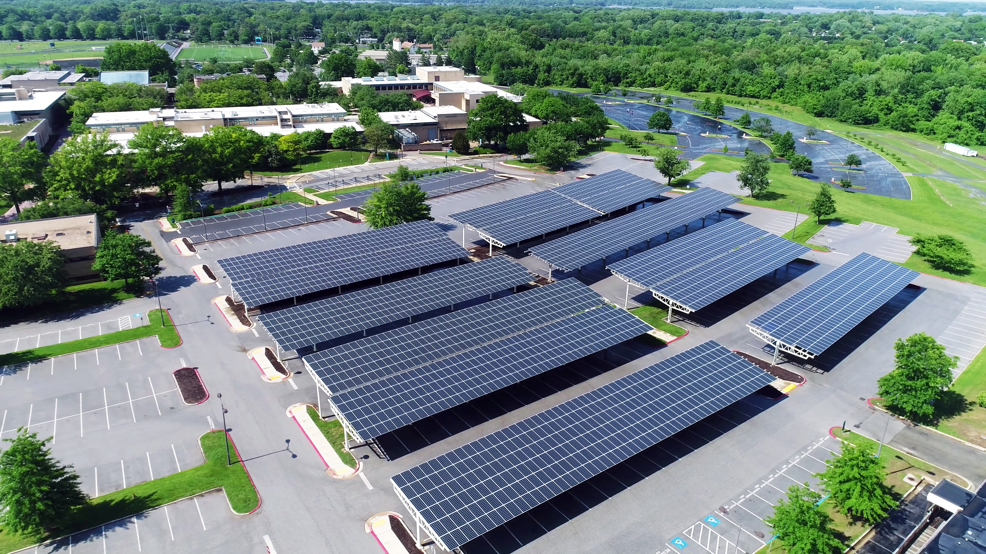 aerial view of solar panels installed in roof of parking