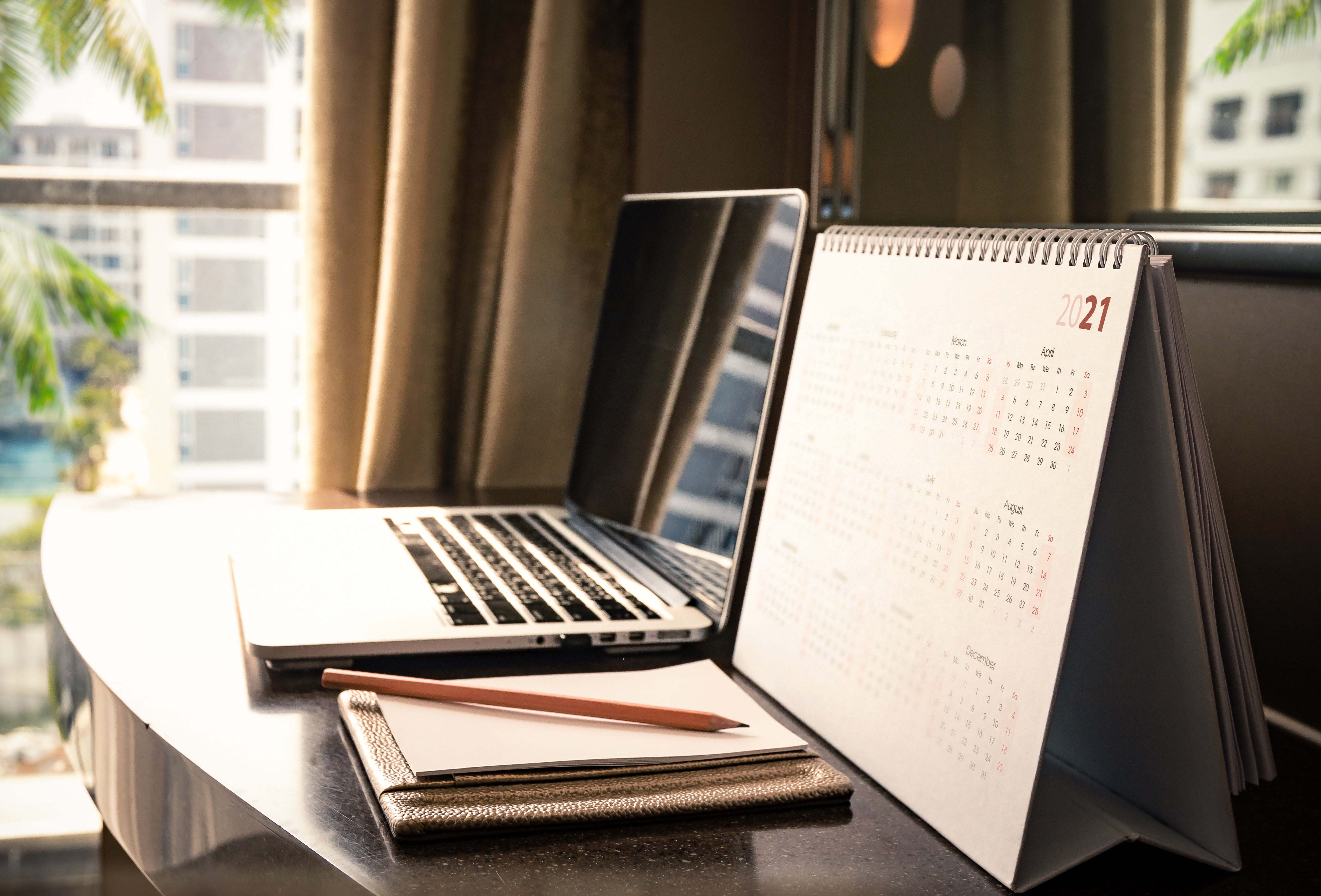 Laptop and calendar on desk