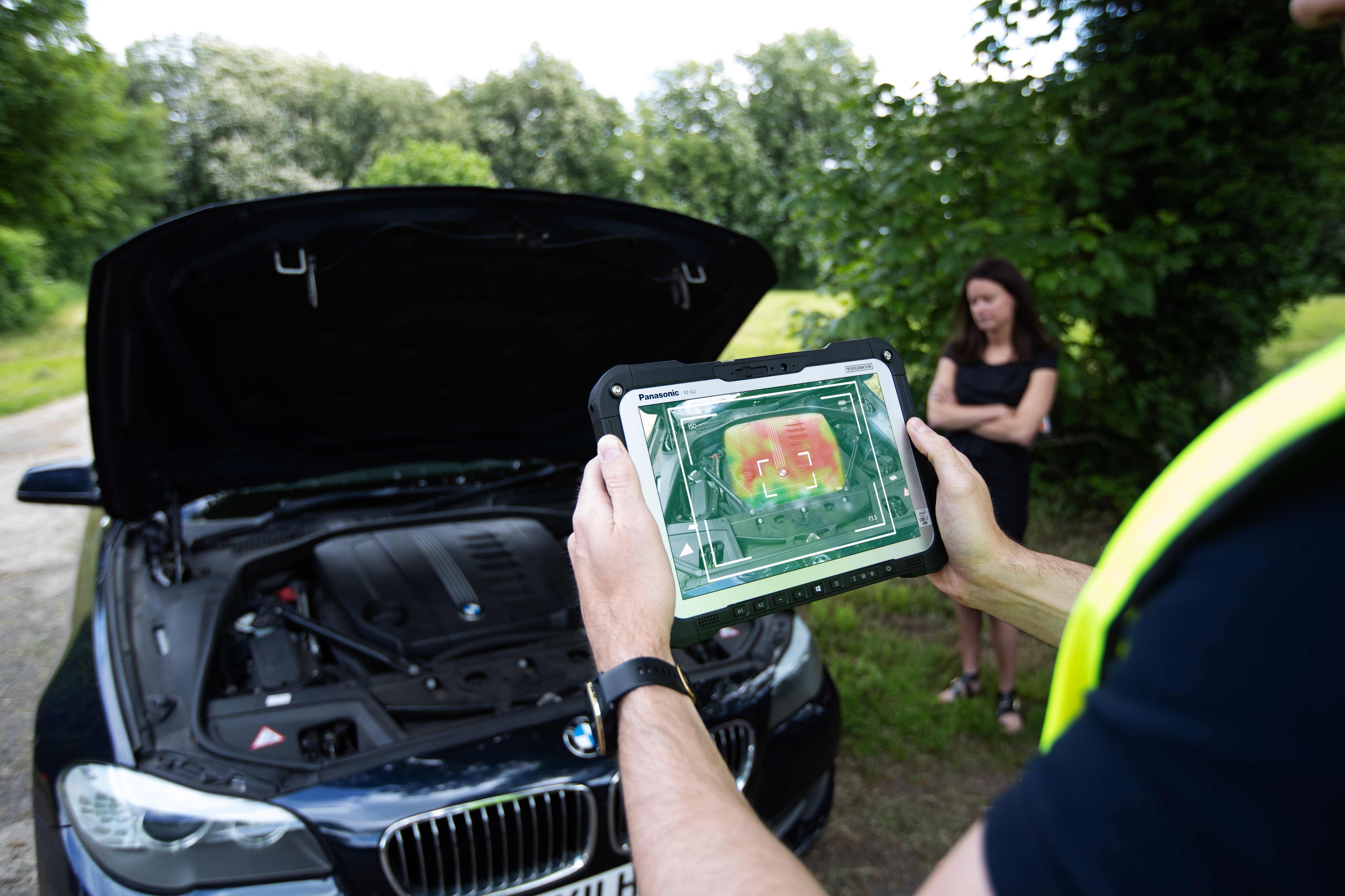 A modular laptop taking a picture of a car trunk