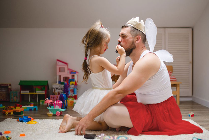 Fotografija hčerke, ki šminka očeta in se z njim igra domišjijsko igro - Simbolna fotografija za predloge skupnih aktivnosti očka z otrokom