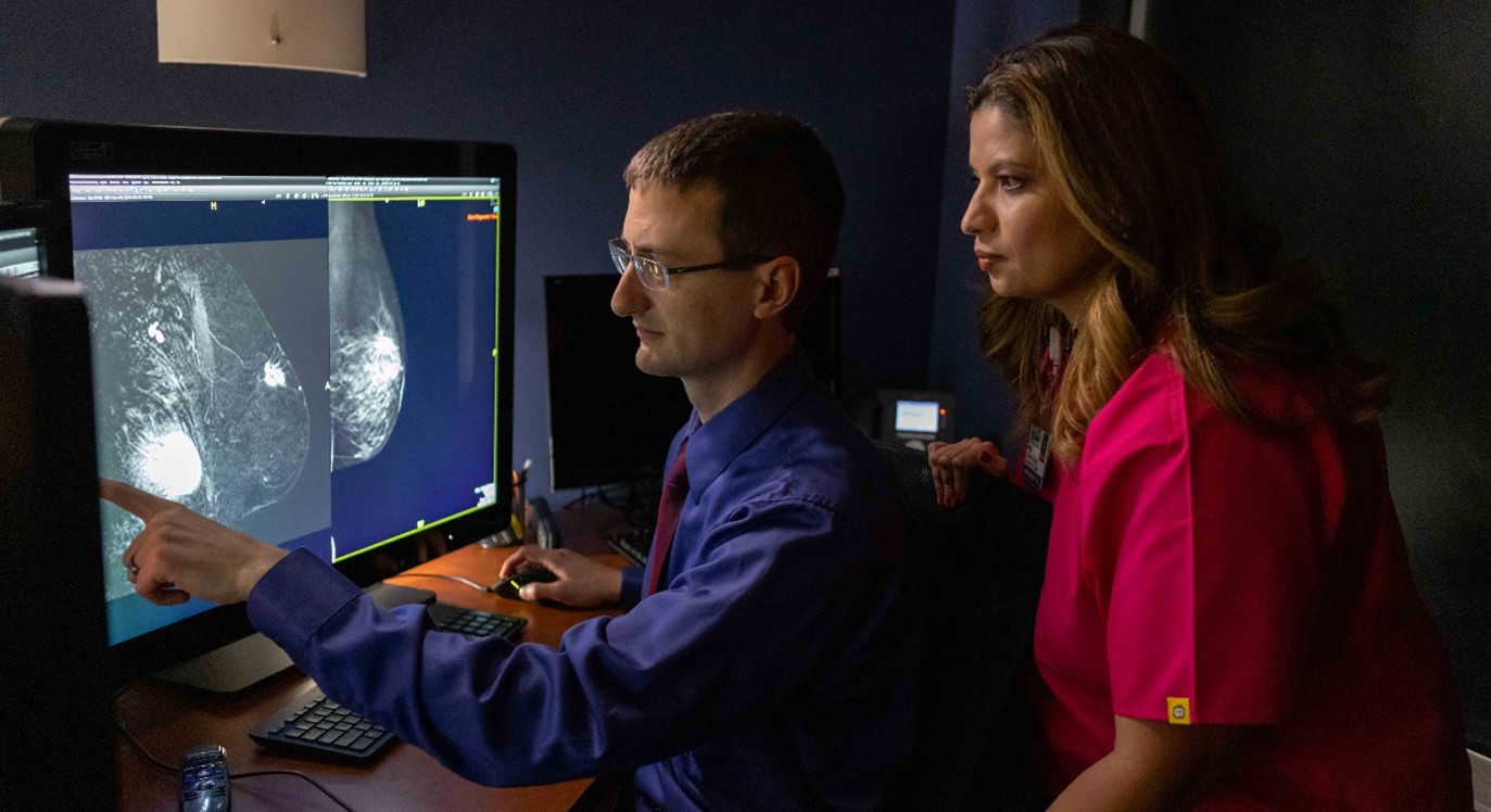 radiologist and technologist reading mammography clinical images