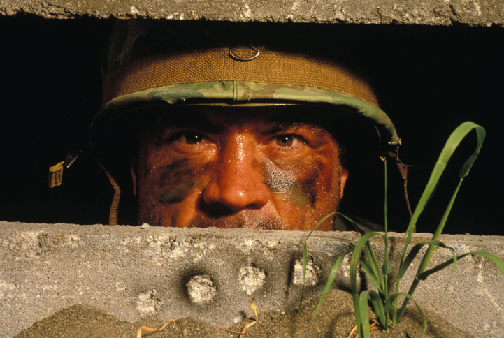 Male Soldier Staring Out Of Bunker