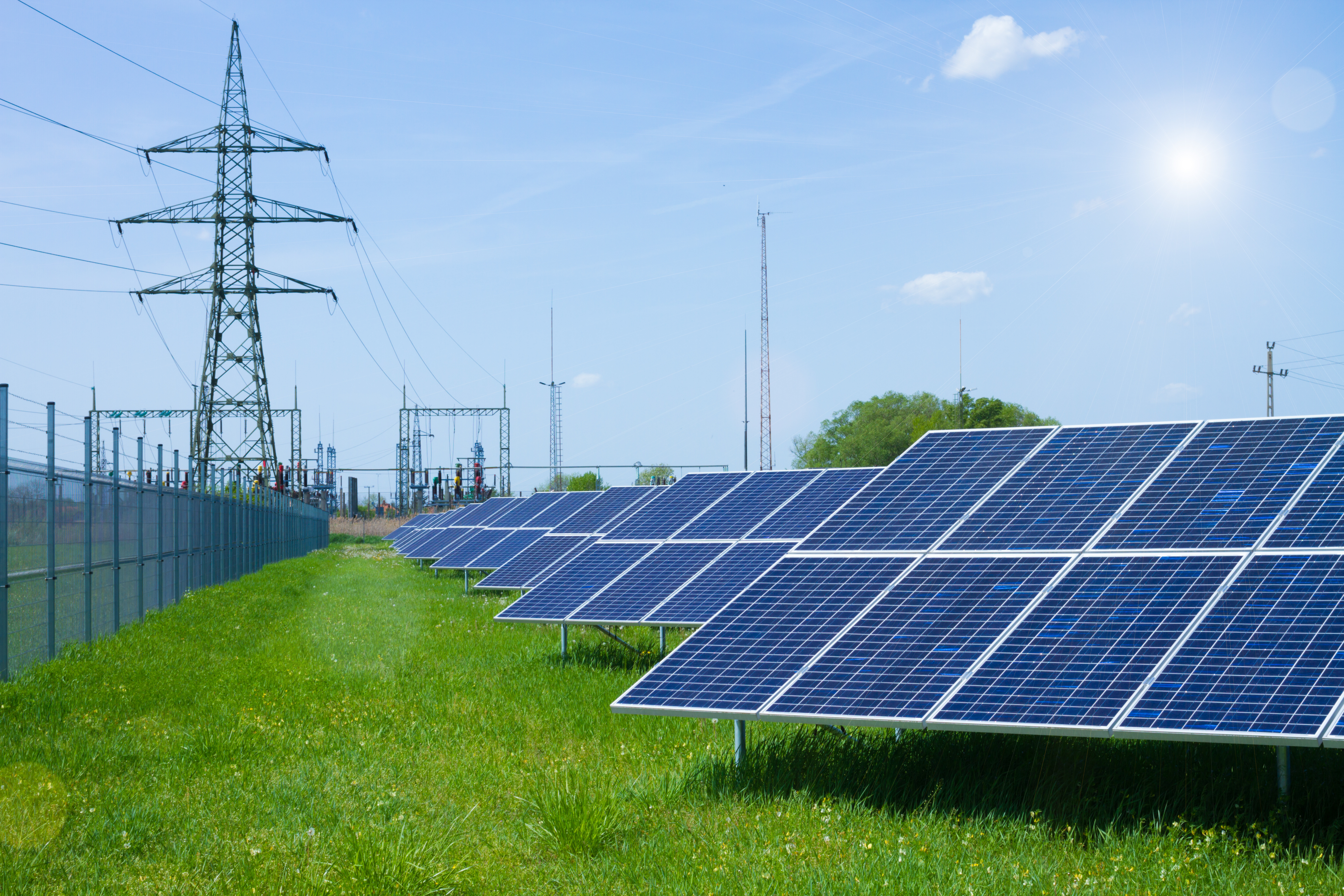 solar panel against high voltage tower