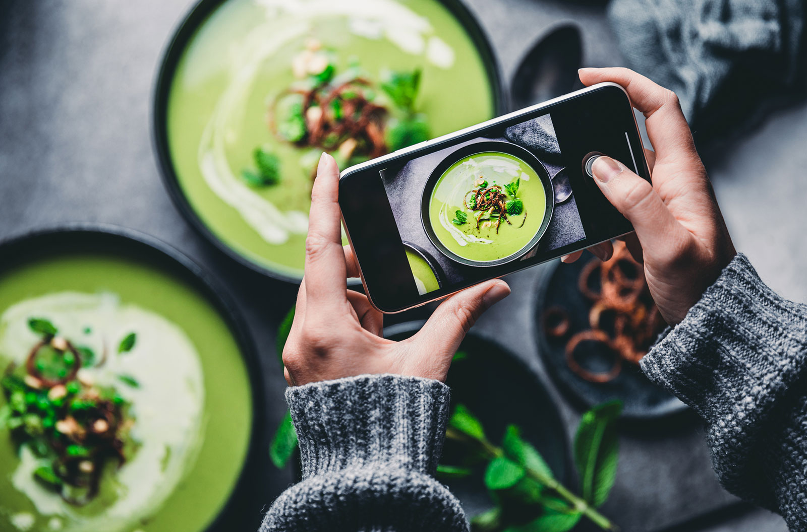 Woman photographing fresh soup