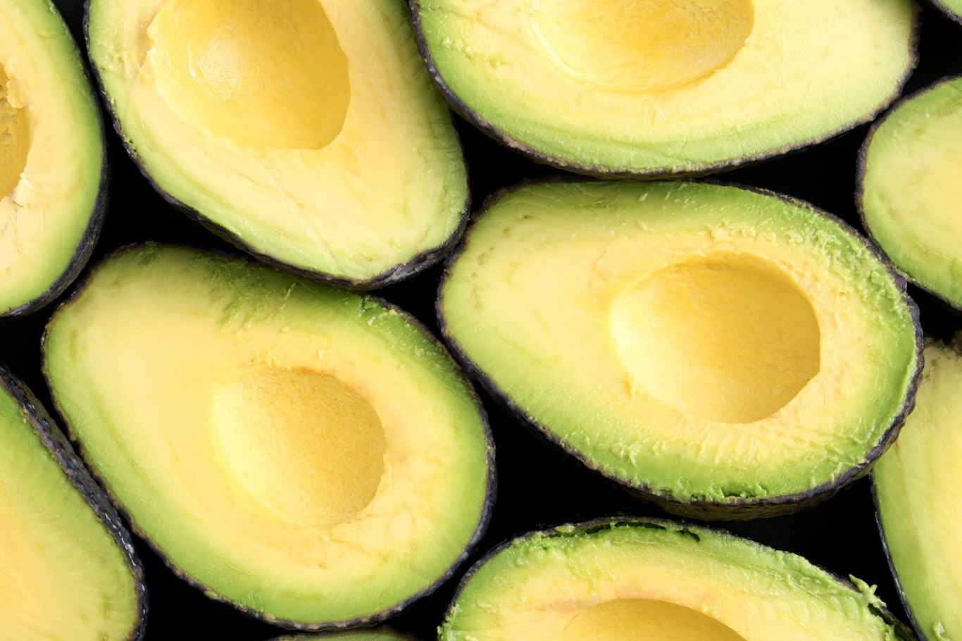 Royalty-Free photo: Avocado fruit on chopping board beside green handled  knife