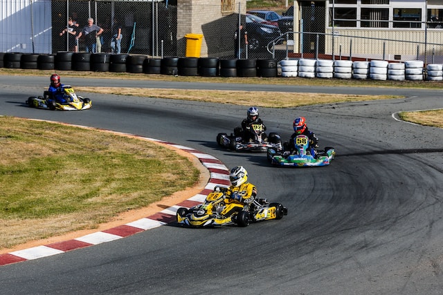 young people racing go karts
